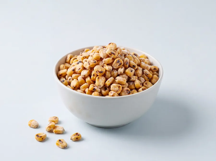 Fire-roasted sweet corn kernels in a white bowl